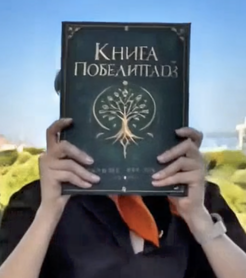 The outdoor shot with the green replacement book, its tree emblem and Cyrillic title, held in both hands.
